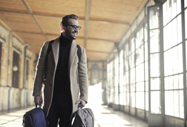 man carrying bags in airport