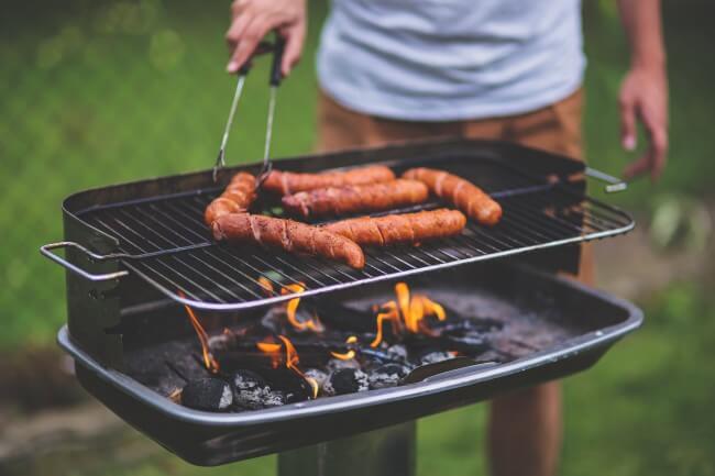 man barbecuing on a grill