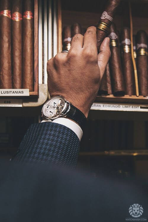 gentleman watch at wrist with cigar