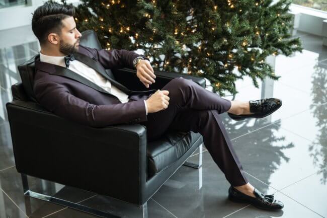 man in suit looking at watch