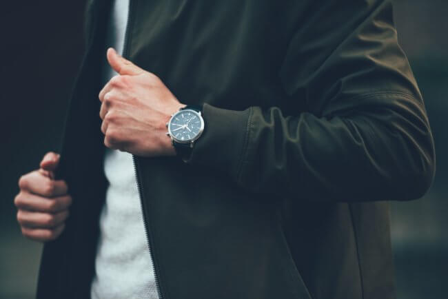 man with wristwatch and jacket