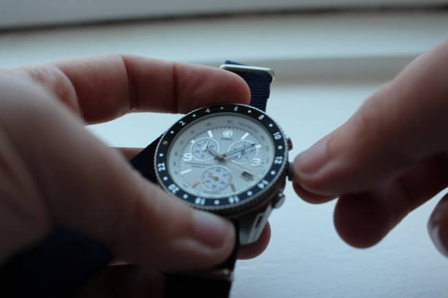 man adjusting watch